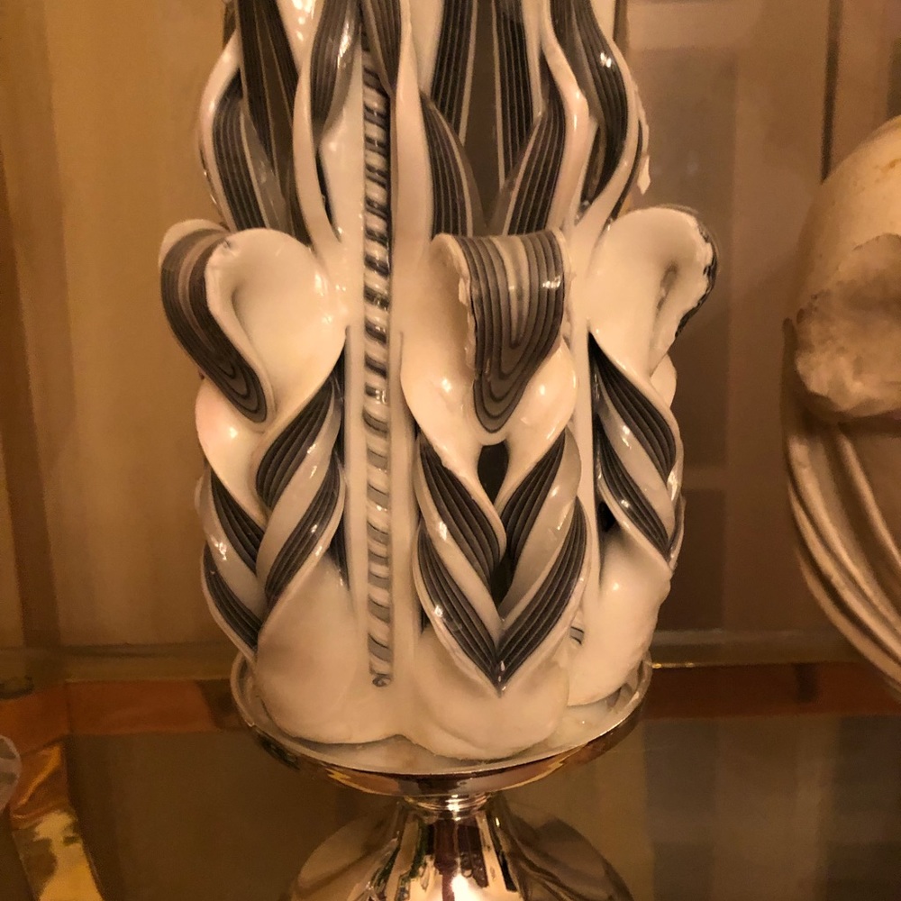 Grey and white candle with candle holder.